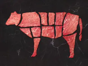 Cuts of beef arranged in cow shape.